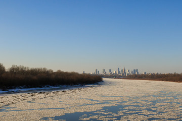 Fototapeta na wymiar Warsaw skyline with frozen Vistula river in sunlight