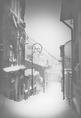 Winter story. Night snowfall in a silent street of the city.