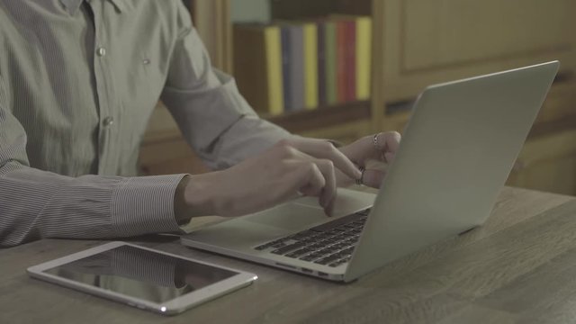 oung man hands using notebook on a table, 4k ungraded footage shot in 24fps