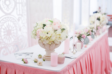 Wedding ceremony decoration in the restaurant. Decoration of wedding table with tender pink textile