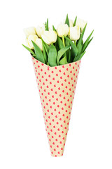 Bouquet of white tulips wrapped in paper with hearts. Isolated over white background 