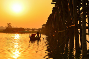 boat on U-Bein bridge during sunrise, Mandalay Myanmar