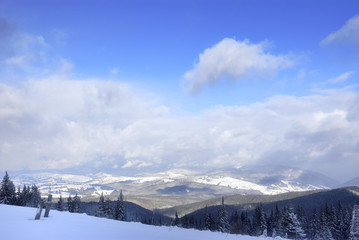 Fototapeta premium Contrast transition between ground end sky. Dramatic clouds under snowed mountains 