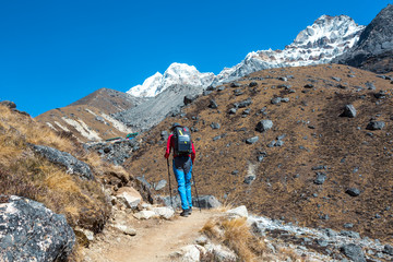 Mountain Hiker walking with Backpack and Solar Battery