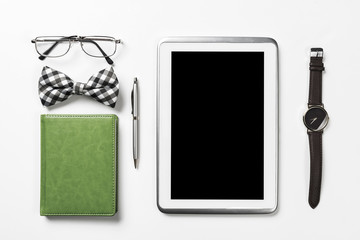 Gentleman kit of tablet watch glasses bow tie and notebook on wo