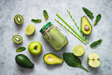 Healthy green food background - smoothie and ingredients.
