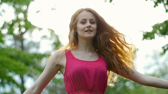 attractive girl with red hair enjoying nature