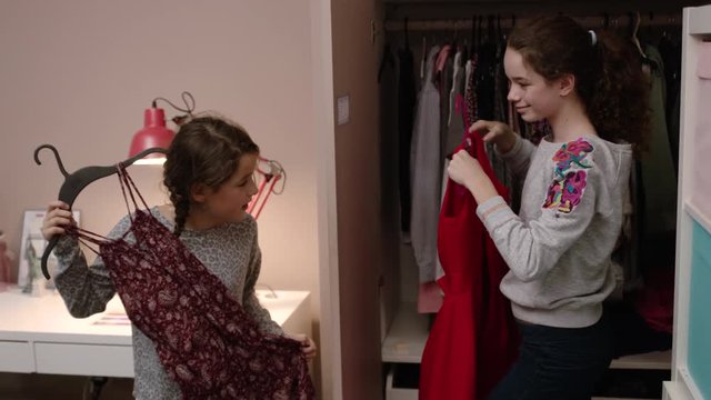 Sisters picking out clothes to wear