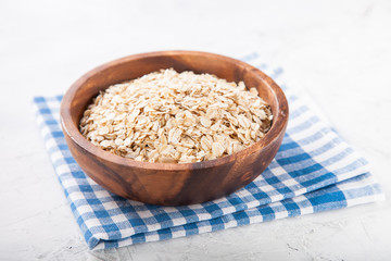 Oat flakes in a bowl on a table, selective focus, copy space