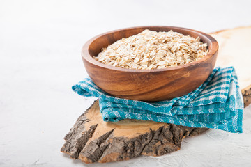 Oat flakes in a bowl on a table, selective focus, copy space