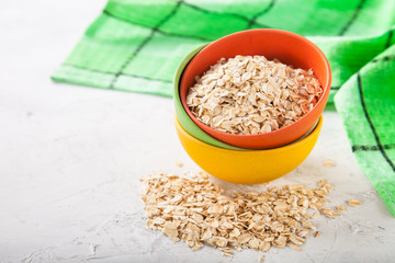 Oat flakes in a bowl on a table, selective focus, copy space