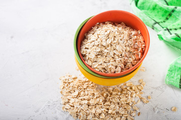 Oat flakes in a bowl on a table, selective focus, copy space
