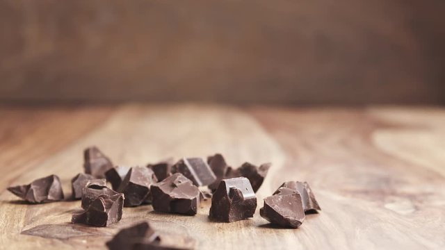 chocolate chunks falling on wooden table in slow motion, 180fps prores footage