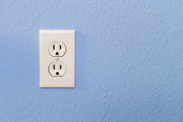 Electrical Sockets In Colorful Blue Wall of House.