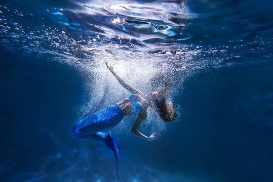 Underwater shot with free diver girl with mermaid tale