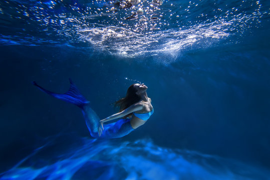 Underwater shot with free-diver girl with mermaid tale