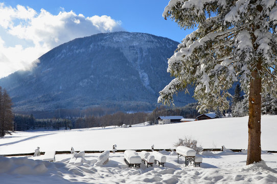 Snow-covered picknick tables, beautiful scenery in tyrol, austria