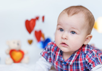 Beautiful baby is smiling. background as a heart.