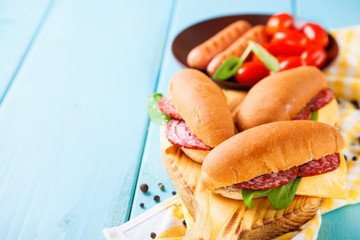 breakfast - sandwiches, sausages and tomatoes on a table, selective focus, copy space