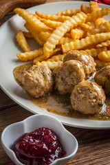 Meatballs with french fries in dill sauce.