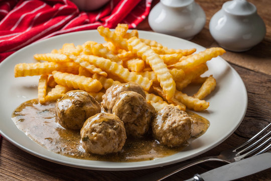 Meatballs with french fries in dill sauce.