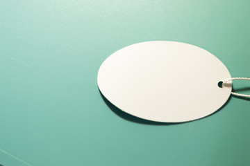 White oval tag on a green background