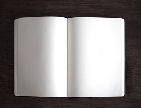open plain notebook on wooden table top