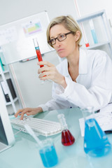 closeup of beautiful lab worker holding up test tube