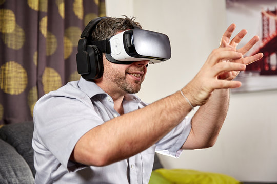 Man with vr virtual reality headset grabbing with hands
