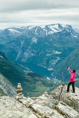 Fototapeta premium Tourist taking photo from Dalsnibba viewpoint Norway