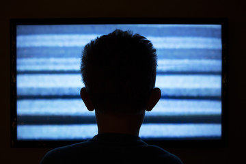 Boy watching television with noise