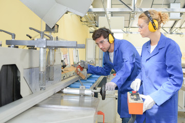 Young people working on industrial machine