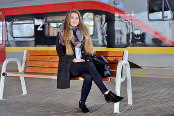Young woman on a train station. © Tomasz Warszewski
