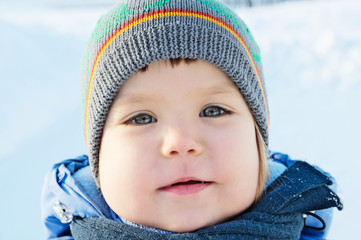 Smiling little girl portrait at winter in warm clothes