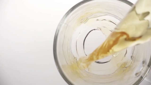 Cloes up of pouring tea into glass tea cup, top view