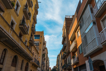 modern and old apartment buildings an a small alley at barcelona