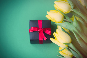 Yellow tulips bouquet and gift box