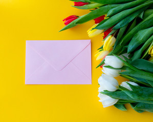Multicolored tulips bouquet and envelope