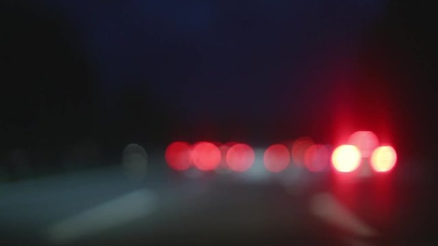 Bokehy car lights in traffic jam on the highway in the night