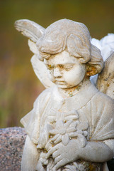 Sad white stone cemetery baby angel statue