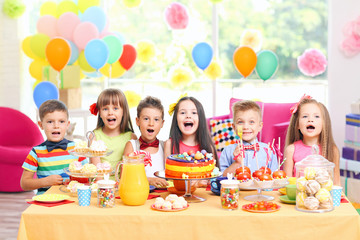 Children's funny birthday party in decorated room