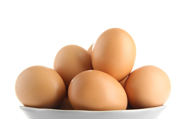 Raw eggs in bowl on white background