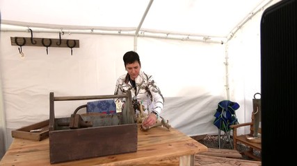 Outdoor Market Craft Vendor selling wood furniture and Southwest silver and turquoise jewelry.