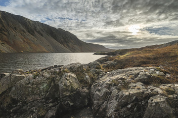 Beautiful sunset landscape image of Wast Water and mountains in