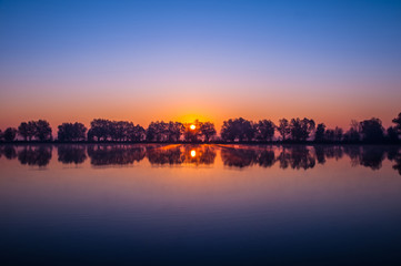 Fototapeta na wymiar Beautiful sunrise on a fishing