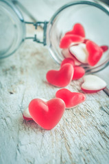 Red heart shape candy in a glass jar