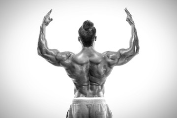 Strong Athletic Man Fitness Model posing back muscles, triceps,