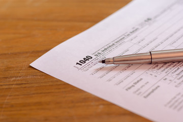 US tax form with pen and calculator selective focus / taxation c