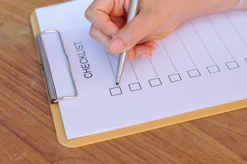 image of businessfemale preparing checklist at office desk