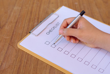 image of businessfemale preparing checklist at office desk
